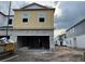 Unfinished two story home with cinder block garage and siding on the second floor at 14930 Harvest St, Orlando, FL 32824