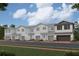 Charming townhome exteriors showcasing a blend of neutral colors and stone accents at 14930 Harvest St, Orlando, FL 32824
