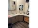 Bright bathroom with light wooden cabinets, a sink, decorative mirror, and flower decor at 158 Rita Bee Ave, Davenport, FL 33897