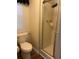 Cozy bathroom featuring a toilet and a shower with glass doors for a refreshing experience at 158 Rita Bee Ave, Davenport, FL 33897