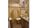 Inviting bathroom features a sink, toilet, and bathtub with shower and curtain at 158 Rita Bee Ave, Davenport, FL 33897