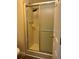Bathroom featuring a shower with sliding glass doors, shower head, and shower handle at 158 Rita Bee Ave, Davenport, FL 33897