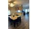 Cozy dining area featuring a marble-topped table with seating for four, wood floors and a view to the kitchen at 158 Rita Bee Ave, Davenport, FL 33897