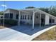 Charming home with a covered carport and enclosed sunroom offering sheltered parking and outdoor living space at 158 Rita Bee Ave, Davenport, FL 33897