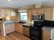 Functional kitchen with stainless steel appliances, light wood cabinetry, and durable countertops at 158 Rita Bee Ave, Davenport, FL 33897
