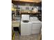 Functional laundry room equipped with a washing machine, dryer, and a utility sink at 158 Rita Bee Ave, Davenport, FL 33897