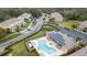 Aerial view of community featuring a pool, playground, and well-maintained landscaping at 17419 Placidity Ave, Clermont, FL 34714