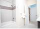 Modern bathroom with a shower-tub combo, updated tile, and neutral color palette at 17419 Placidity Ave, Clermont, FL 34714