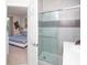 Bright shower area of the bathroom is visible from the open door in the main bedroom at 17419 Placidity Ave, Clermont, FL 34714