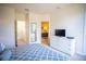 Bright bedroom boasts a TV, white dresser, and ensuite bath access for comfortable living at 17419 Placidity Ave, Clermont, FL 34714