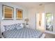 Relaxing bedroom featuring a queen bed, light blue walls, and two attractive wall art pieces at 17419 Placidity Ave, Clermont, FL 34714