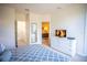 Comfortable bedroom boasts a TV, white dresser, and ensuite bath access for comfortable living at 17419 Placidity Ave, Clermont, FL 34714