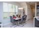 Bright dining area with a modern table setting, large windows, and a contemporary light fixture at 17419 Placidity Ave, Clermont, FL 34714