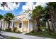 Two-story townhome featuring a covered front porch, manicured landscaping, and a tidy appearance at 17419 Placidity Ave, Clermont, FL 34714
