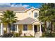 Inviting two-story townhome featuring a covered front porch and well-kept landscaping at 17419 Placidity Ave, Clermont, FL 34714