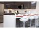 Modern kitchen boasts stainless steel appliances, glossy cabinets, and a convenient breakfast bar with seating for four at 17419 Placidity Ave, Clermont, FL 34714