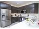 Modern kitchen featuring stainless steel appliances, sleek cabinetry, and ample counter space for culinary enthusiasts at 17419 Placidity Ave, Clermont, FL 34714