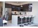 Contemporary kitchen features stainless steel appliances, a stylish island with bar seating, and glossy cabinets at 17419 Placidity Ave, Clermont, FL 34714