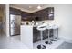 Contemporary kitchen features stainless steel appliances, sleek cabinetry, and a stylish island with bar stools at 17419 Placidity Ave, Clermont, FL 34714