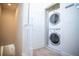 Efficient laundry area with stacked washer and dryer for space-saving convenience at 17419 Placidity Ave, Clermont, FL 34714