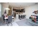 Bright living space boasts an open floor plan, connecting the dining area and kitchen with a breakfast bar at 17419 Placidity Ave, Clermont, FL 34714