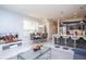 Comfortable living room featuring a modern kitchen, a dining area, and a cozy seating space with a TV at 17419 Placidity Ave, Clermont, FL 34714