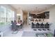 Open-concept living area features modern kitchen with stainless steel appliances, dining area, and sleek decor at 17419 Placidity Ave, Clermont, FL 34714