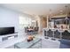 Inviting open-concept living area with a dining space, modern kitchen, and comfortable seating area at 17419 Placidity Ave, Clermont, FL 34714