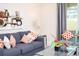 Comfortable living room features a blue sofa with patterned cushions, plus a matching chair at 17419 Placidity Ave, Clermont, FL 34714