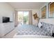 Relaxing main bedroom with balcony access, soft lighting, and stylish decor at 17419 Placidity Ave, Clermont, FL 34714