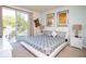 Bright main bedroom with balcony, decorative wall art and calming color palette at 17419 Placidity Ave, Clermont, FL 34714