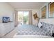 Relaxing main bedroom with balcony access, soft lighting, and stylish decor at 17419 Placidity Ave, Clermont, FL 34714