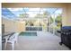 Enclosed patio features a private spa, outdoor seating, and a grill, perfect for relaxation and entertaining at 17419 Placidity Ave, Clermont, FL 34714