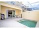 Private patio with a spa, outdoor seating, and an open view to the interior living space at 17419 Placidity Ave, Clermont, FL 34714