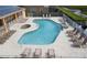 Community pool and hot tub with plenty of loungers for relaxation and sunbathing at 17419 Placidity Ave, Clermont, FL 34714