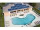 Community pool and hot tub with plenty of loungers for relaxation and sunbathing at 17419 Placidity Ave, Clermont, FL 34714