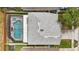 Aerial view of a home with a screen-enclosed pool and spa, alongside a gray shingle roof at 1758 Bobtail Dr, Maitland, FL 32751