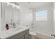 Well-lit bathroom featuring a grey vanity with a white countertop and a shower-tub combo at 1758 Bobtail Dr, Maitland, FL 32751