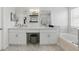 Bright bathroom featuring double sinks, vanity area, basket storage, and a soaking tub at 1758 Bobtail Dr, Maitland, FL 32751