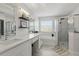Bright bathroom featuring double sinks, vanity area, basket storage, and a glass shower at 1758 Bobtail Dr, Maitland, FL 32751