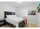 Comfortable bedroom with a black wooden bed frame, soft bedding, and natural light at 1758 Bobtail Dr, Maitland, FL 32751