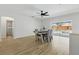 Open dining area with light wood floors, a modern ceiling fan and sliding glass doors at 1758 Bobtail Dr, Maitland, FL 32751