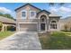 Charming two-story home featuring a well-maintained lawn and a two-car garage at 1758 Bobtail Dr, Maitland, FL 32751