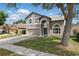 Charming two-story home with a well-maintained lawn, arched entry, and neutral-colored facade at 1758 Bobtail Dr, Maitland, FL 32751
