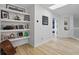Bright hallway featuring floating shelves with decorations and a view of a bedroom at 1758 Bobtail Dr, Maitland, FL 32751