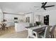Modern kitchen with white cabinets, stainless steel appliances, and a dining table at 1758 Bobtail Dr, Maitland, FL 32751
