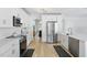 Bright kitchen boasts stainless steel appliances, white cabinetry, and wood-look floors at 1758 Bobtail Dr, Maitland, FL 32751