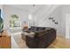 Sunlit living area showcases a large gray sectional sofa, staircase, and stylish decor at 1758 Bobtail Dr, Maitland, FL 32751