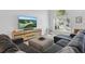 Cozy living room with a gray sectional sofa, natural wood entertainment center and scenic outside views at 1758 Bobtail Dr, Maitland, FL 32751