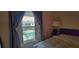 Relaxing bedroom view with curtains overlooking a sparkling community pool at 200 Maitland Ave # 232, Altamonte Springs, FL 32701